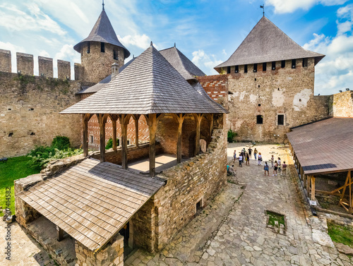 KHOTYN, UKRAINE - JULY 02, 2021, courtyard inside the Khotyn fortress. A group of tourists on an excursion. photo