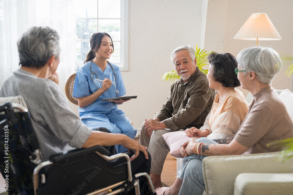 Group of Asian senior people sit in a circle in a nursing home and listen to nurse during a group elderly therapy session. Group of Asian senior people sit in a circle in a nursing home and listen to nurse during a group elderly therapy session.