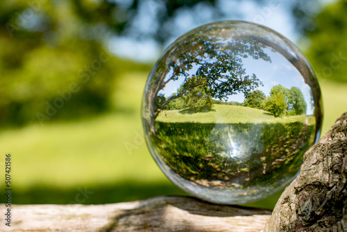 Photograhing a crystalball with nature inside in Scandinavia in springtime. It shows how to be inspired in innovation processes by nature.
