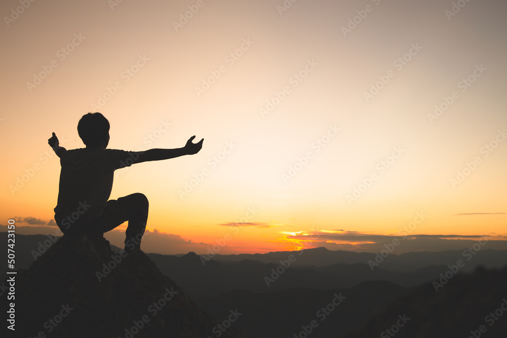 Silhouette with outstretched arms in sunset concept for religion, worship, prayer and praise, the power of hope or love and loyalty. Faith in goodness. Power of success.