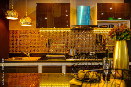 Fotografie modern luxury kitchen premium home decoration dim light night black golden tone