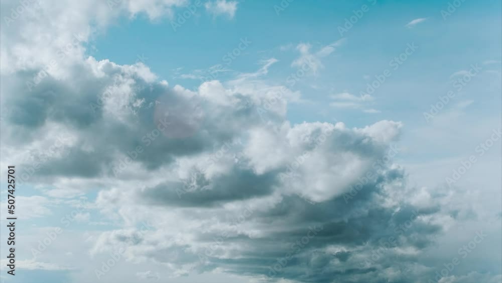 Blue summer sky with thick thunderstorm clouds moving across. From fluffy white clouds to dark rain clouds. Fast cloud formation and motion time lapse Blue summer sky with thick thunderstorm clouds moving across. From fluffy white clouds to dark rain clouds. Fast cloud formation and motion time lapse