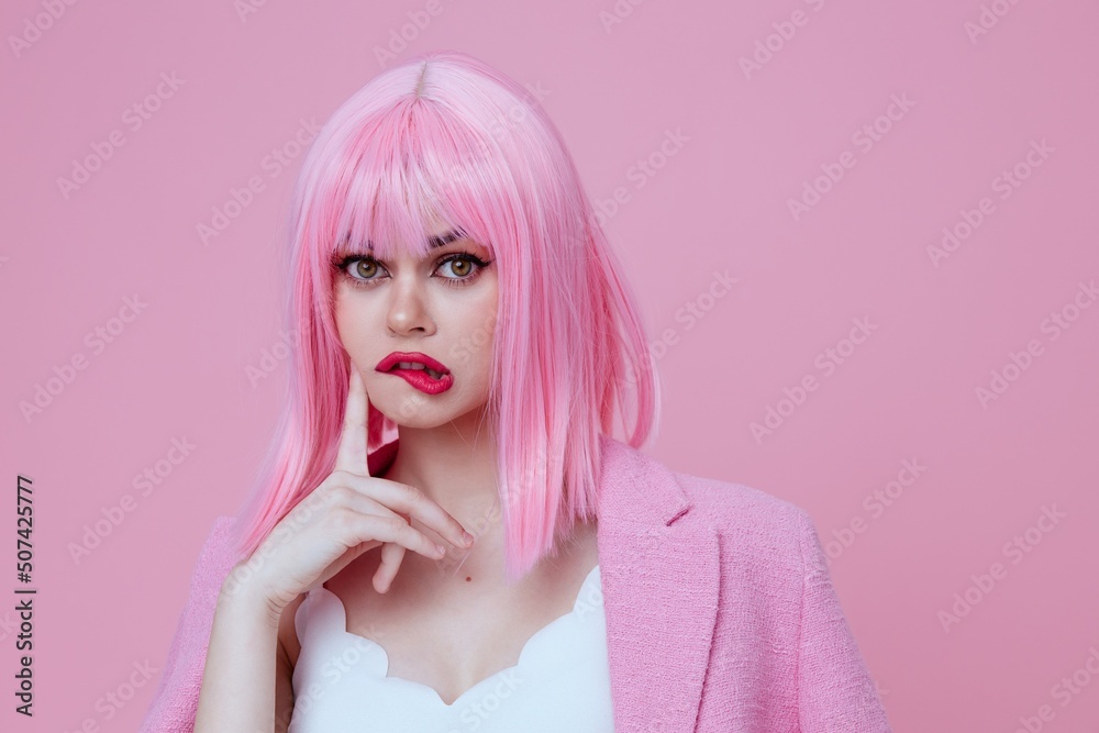 Portrait of a charming lady gestures with his hands with a pink jacket pink background unaltered Portrait of a charming lady gestures with his hands with a pink jacket pink background unaltered