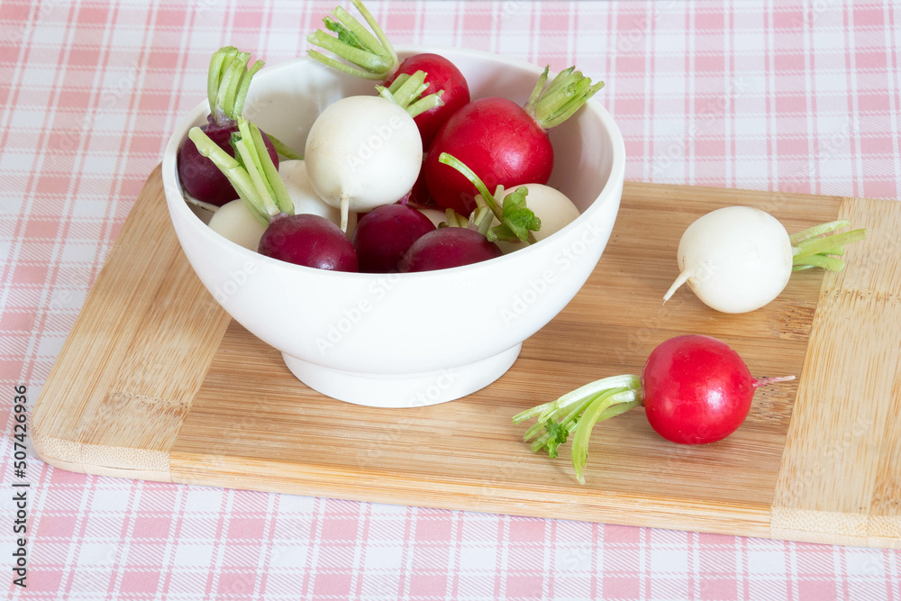 tricolor radishes in a bowl on a table tricolor radishes in a bowl on a table