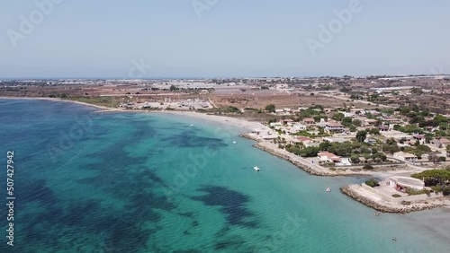 Aerial drone view of the beach and harbour of Portopalo di Capo Passero. Turquoise water in Sicily. photo