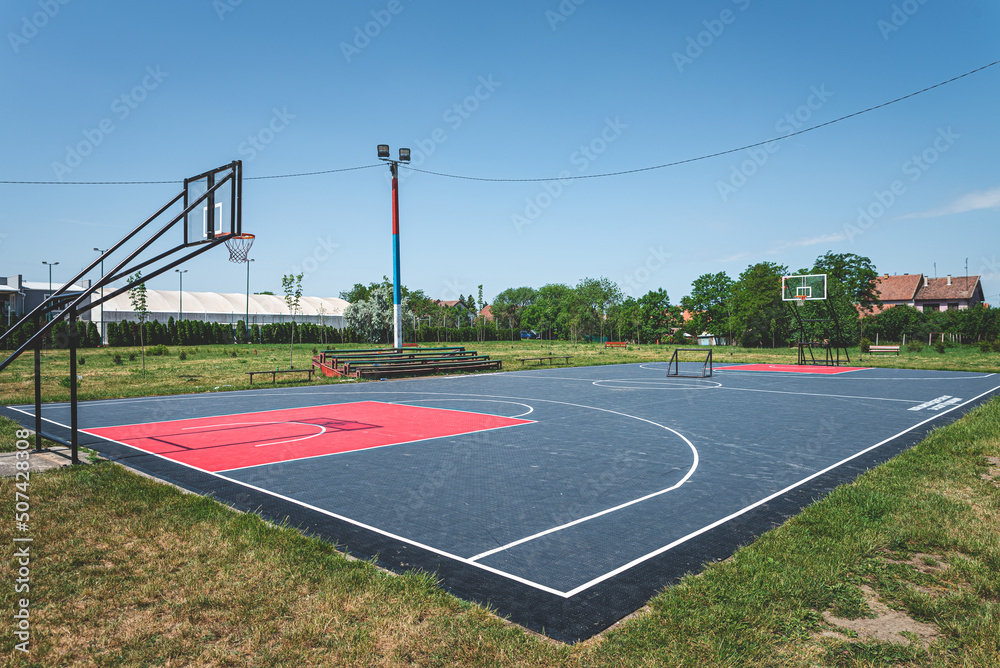 new outdoor basketball court with rubber surface