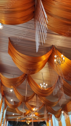 the white golden wedding decorations on the ceiling and wall to make the room more luxury and beautiful