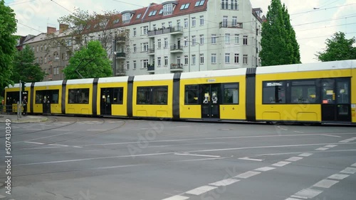 Yellow Tram in Berlin on road. Streetcar in Germany. Public transport with Tram