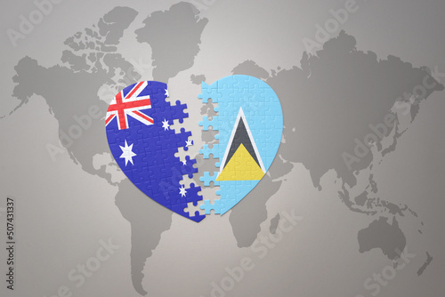 puzzle heart with the national flag of saint lucia and australia on a world map background. Concept.