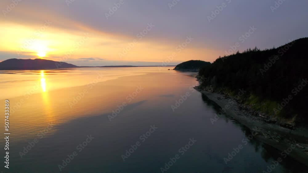 Aerial view of gorgeous sunset along Pacific Northwest coast. Drone footage of Larrabee Beach State Park near Bellingham, Washington at dusk. Aerial view of gorgeous sunset along Pacific Northwest coast. Drone footage of Larrabee Beach State Park near Bellingham, Washington at dusk.
