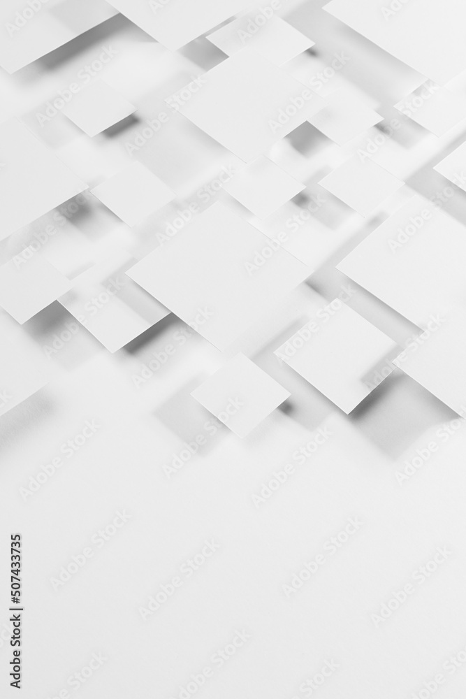 White geometric texture with flying rhombuses as pattern in sunlight with soft gradient grey shadows as border, copy space, top view, vertical. Simple abstract background in minimal style.