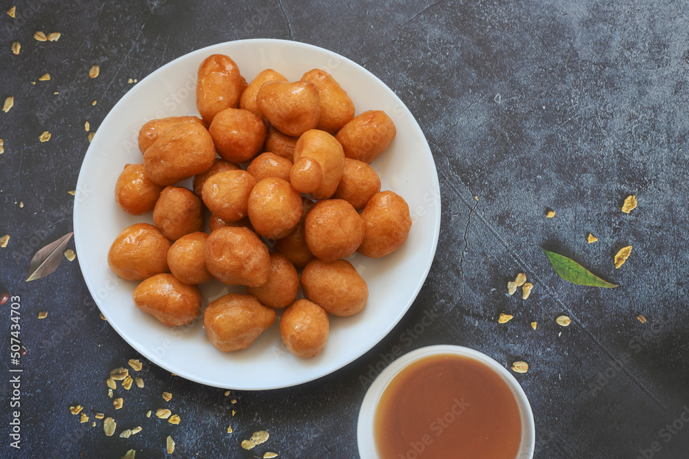 A bowl of Lokma (Turkish), loukoumades (Greeek ) with other names in other languages, are pastries made of leavened and deep fried dough, soaked in syrup or honey, sometimes coated with cinnamon A bowl of Lokma (Turkish), loukoumades (Greeek ) with other names in other languages, are pastries made of leavened and deep fried dough, soaked in syrup or honey, sometimes coated with cinnamon
