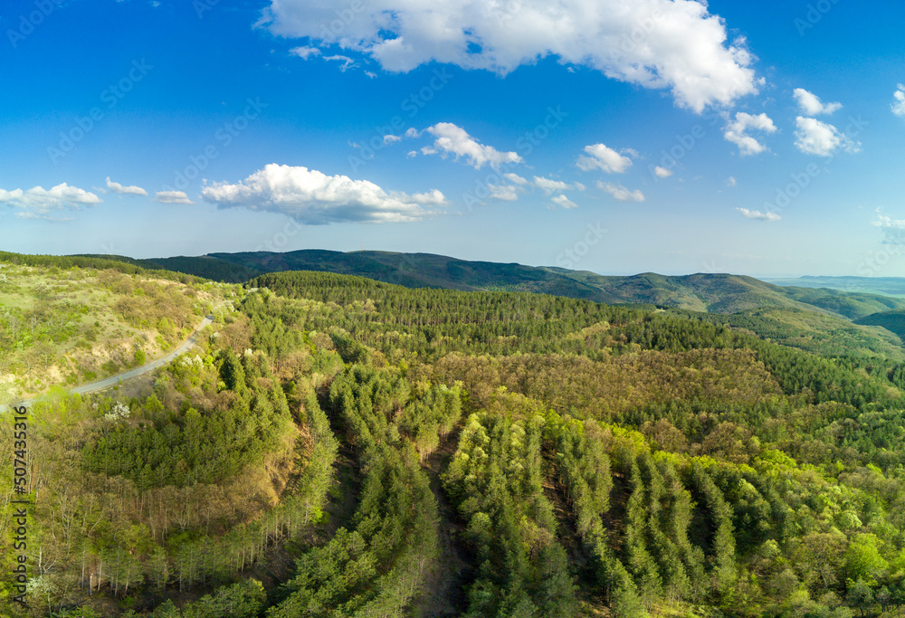 Panorama of a view from a height of the meadows and slopes of the Balkan Mountains under daylight in Bulgaria