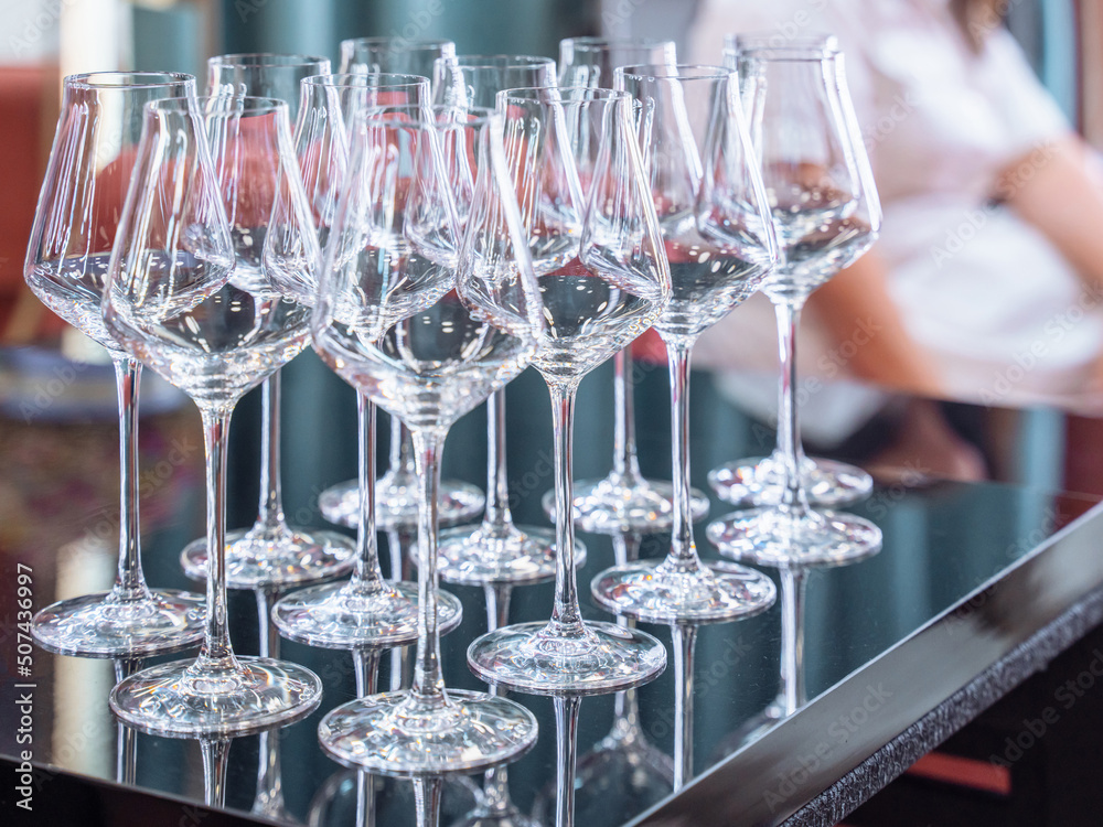 close up perspective of crystal clear empty wine glasses with slim stem on counter top bar close up perspective of crystal clear empty wine glasses with slim stem on counter top bar