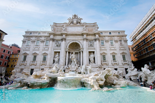  Trevi fountain with clear blue water against vintage Rome building as popular tourist destination. Historical sculpture and architecture sightseeing on May 06 in Rome