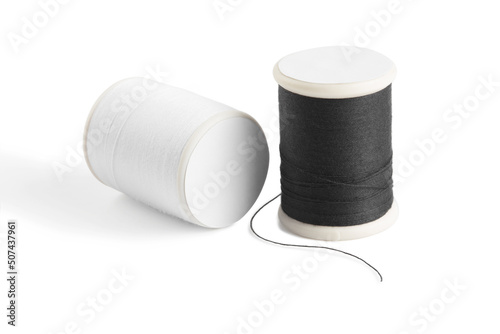 white and black sewing thread spool on a white