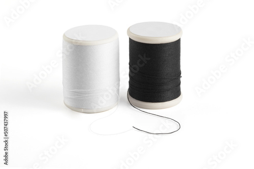 Slika na platnu white and black sewing thread spool on a white