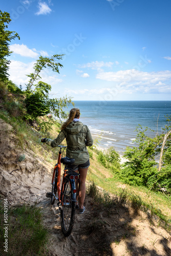 Frau mit Fahrrad an der Ostseeküste von Usedom