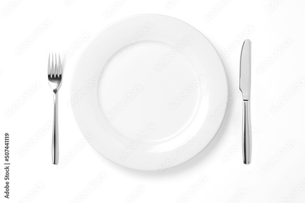 Empty plate with knife and fork isolated on a white background. Empty plate with knife and fork isolated on a white background.