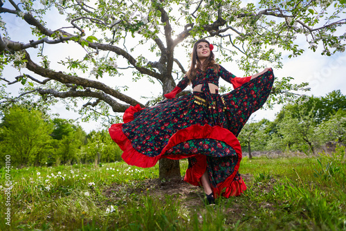 Young woman in gypsy costume dancing