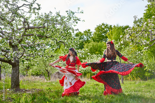 Gypsy girls dancing in the orchard