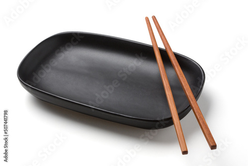 wooden chopsticks on black oval plate