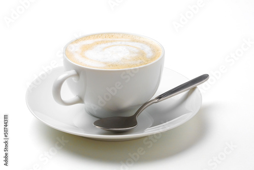 Cappuccino coffee in white coffee cup with saucer and spoon