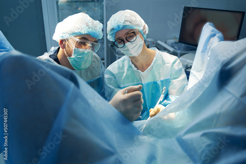 Woman using surgical scissors for cutting tissue during surgery