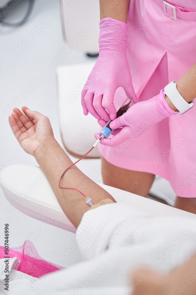 Naklejka premium Woman lies in a medical office on a plasmolifting procedure