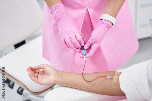 Platelet-rich plasma given intravenously to a woman in medical cabinet photo