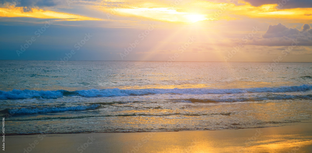 Panoramic beach landscape. Inspire tropical beach seascape horizon. Orange and golden sunset sky calmness tranquil relaxing sunlight summer mood. Wide photo.