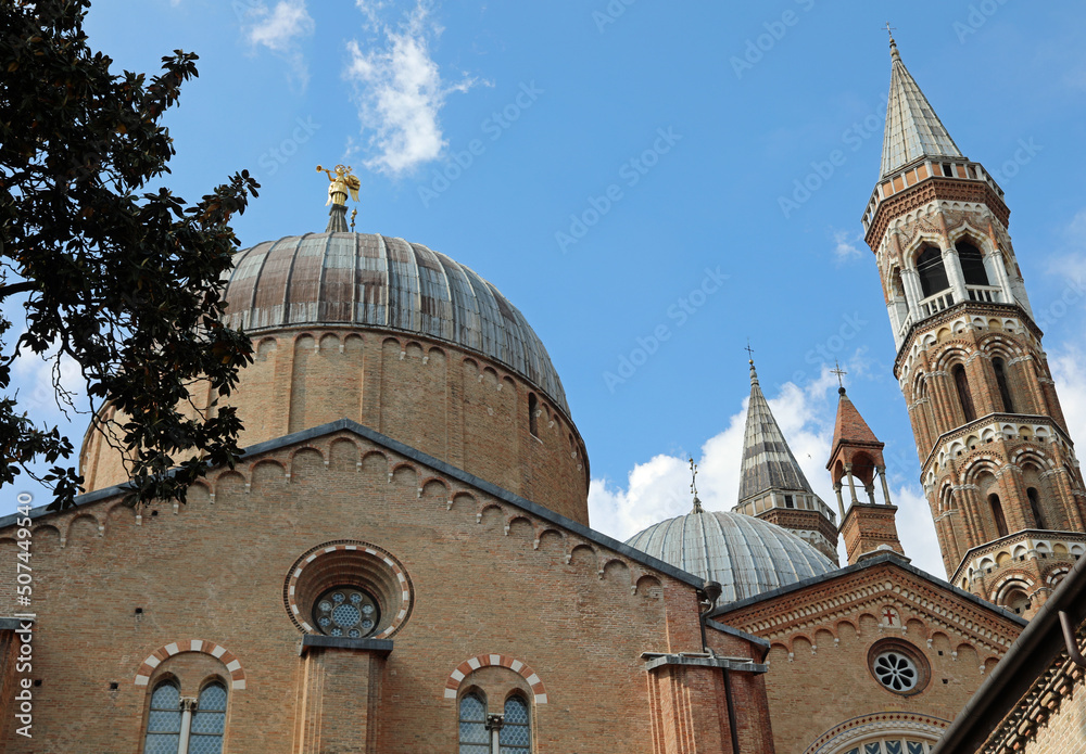 Bell towers and dome of the Basilica of Saint Anthony from Padua also called SANTO ANTONIO in Italian language in Padova City in Italy and the golden angel used as a weather vane