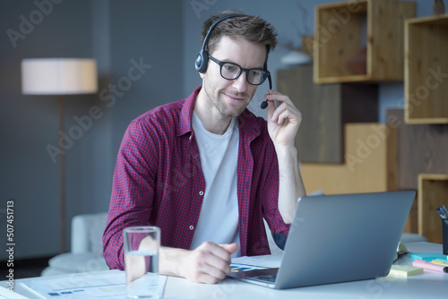 Friendly german guy call center agent consulting client online