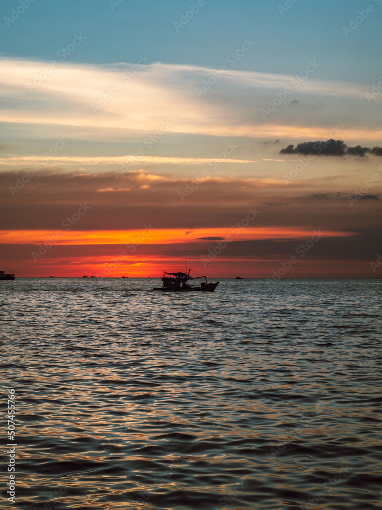 Beautiful silhouette of a fisher boat at sunset at the sea in Vietnam Beautiful silhouette of a fisher boat at sunset at the sea in Vietnam