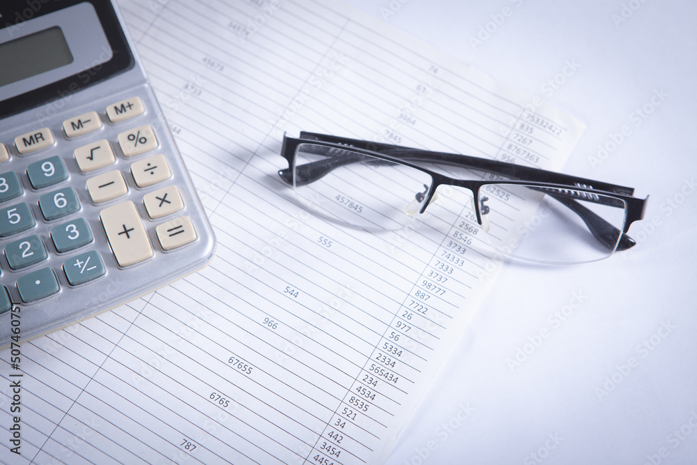Close up calculator and financial report - accounting concept Close up calculator and financial report - accounting concept