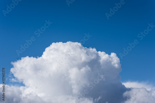 Fluffy soft huge cloud on the blue sky