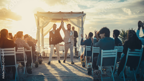 Tableau sur toile Handsome Gay Couple Exchange Rings and Kiss at Outdoors Wedding Ceremony Venue Near the Sea