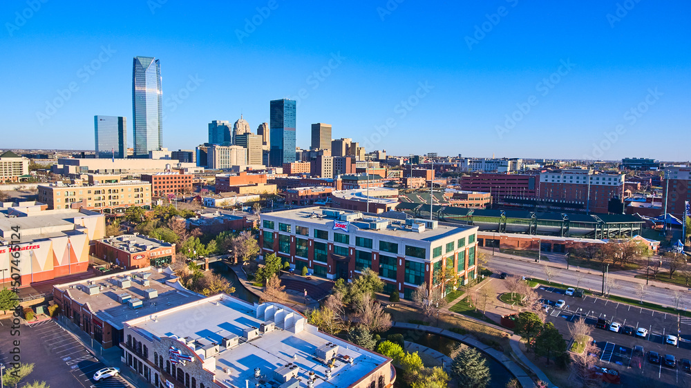 Aerial over shopping area in Oklahoma City with downtown in distance