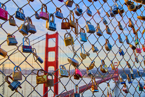 Canvas Print Chain link fence covered in locks with hole revealing Golden Gate Bridge in back