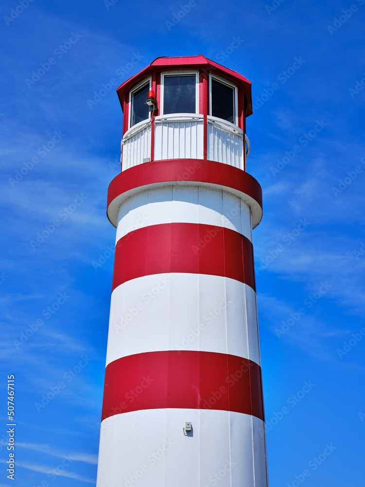 Red-white lighthouse on Lake Neusiedlersee in Podersdorf, Austria