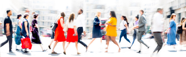 Lots of people walking on the city street. Blurred long time exposure image representing busy life of the big modern capital