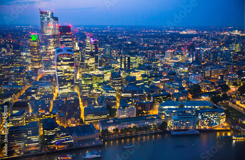 City of London at sunset. View include modern skyscrapers, banks and office buildings and river Thames