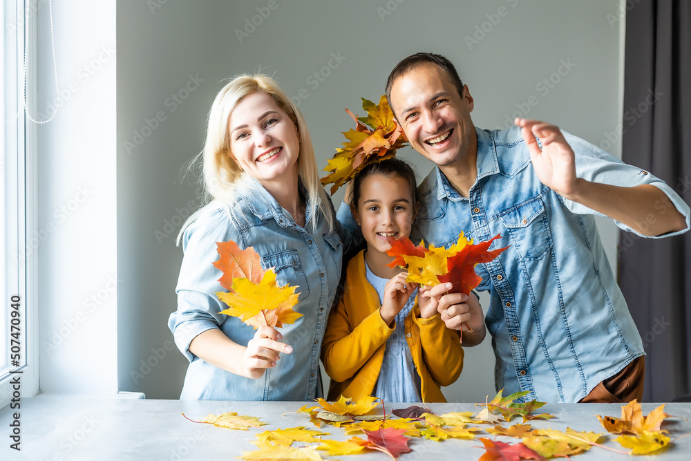 Fototapeta premium family At Home Doing Craft And Making Picture From Leaves In Kitchen