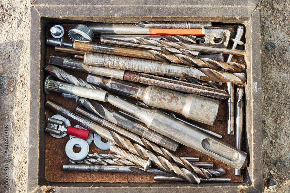 a set of metal drills of different diameters in a box