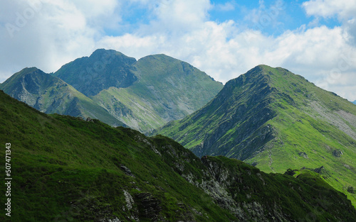 The sharp, rocky mountain peaks in Retezat mountains covered by green alpine pastures, Carpathia, Romania
 photo