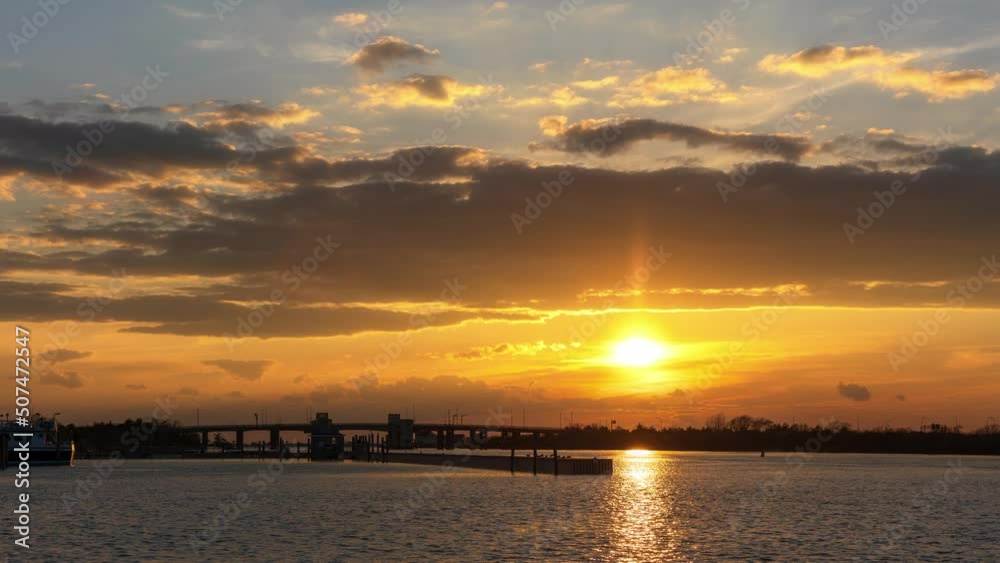 Vibrant coastal sunset time lapse, with a small bridge crossing the water. Captree State Park New York Vibrant coastal sunset time lapse, with a small bridge crossing the water. Captree State Park New York