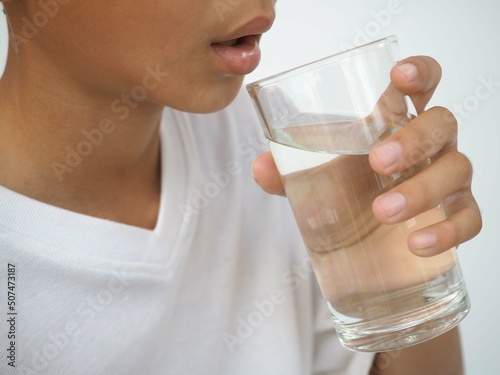 Child drinks water. health concept. closeup photo, blurred.