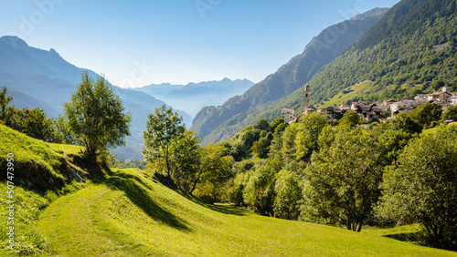 Nice autumn view on the gorgeous village of Soglio, located on the mountainside on the northern side of the Val Bregaglia (Grisons, Switzerland). In the background lies the Italian border. photo