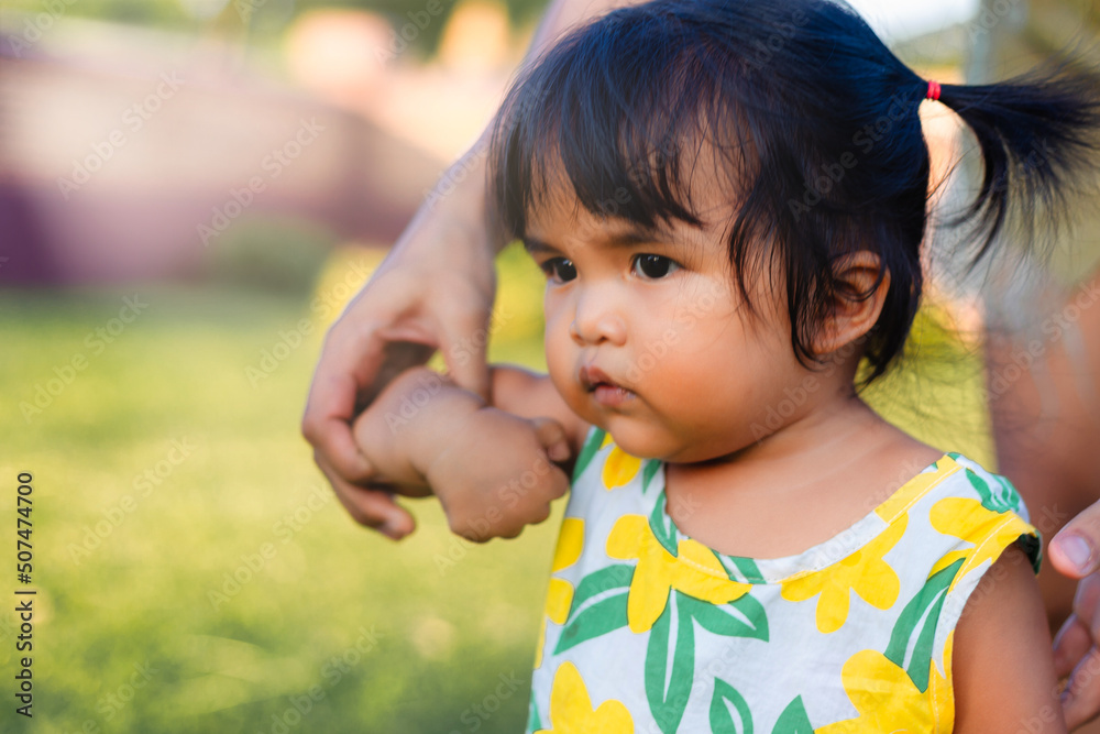 asian happy little girl play in park with mother hand in hand asian happy little girl play in park with mother hand in hand