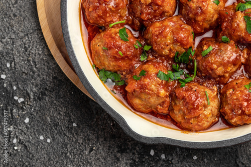 Traditional spicy meatballs in sweet and sour tomato sauce. Restaurant menu, dieting, cookbook recipe top view
